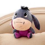 Plush donkey toy on a beige surface