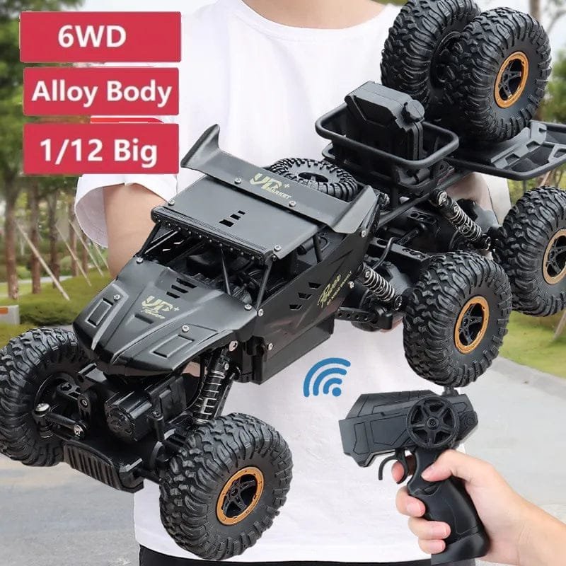 6WD RC truck held in hand to show its large alloy body for outdoor high-speed play.