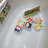 Colorful educational bath toys shaped like trains with animal illustrations on a white surface.