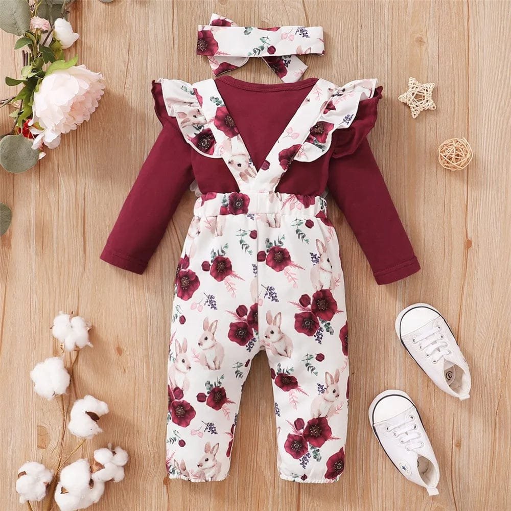 Children's outfit with floral pattern on a wooden surface
