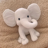 Plush elephant toy on a beige carpet