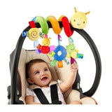 Baby in a car seat with colorful toy hanging above