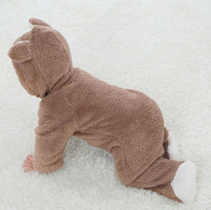 Brown plush toy resembling a sloth on a white surface