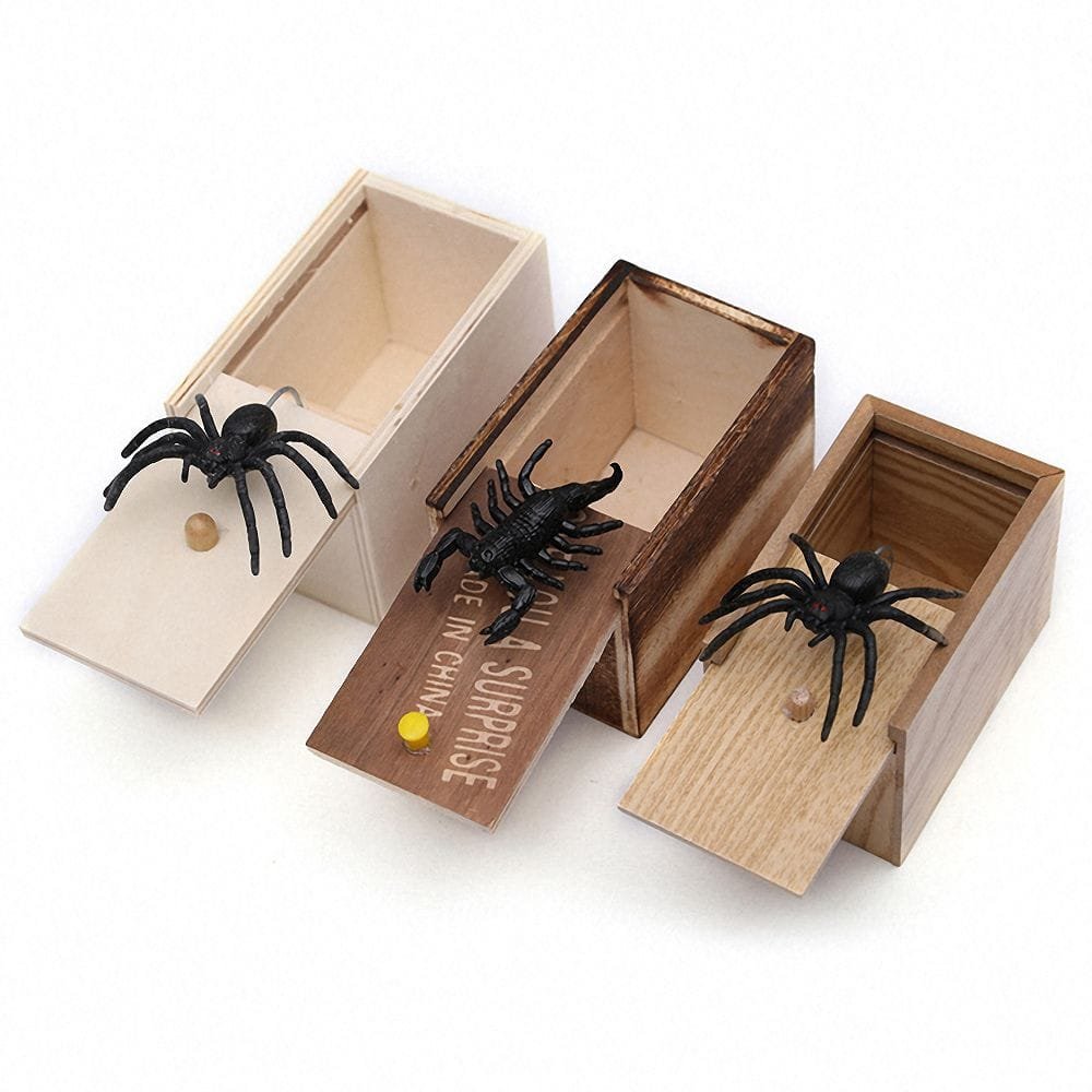 Three wooden boxes with spider toys on a white background