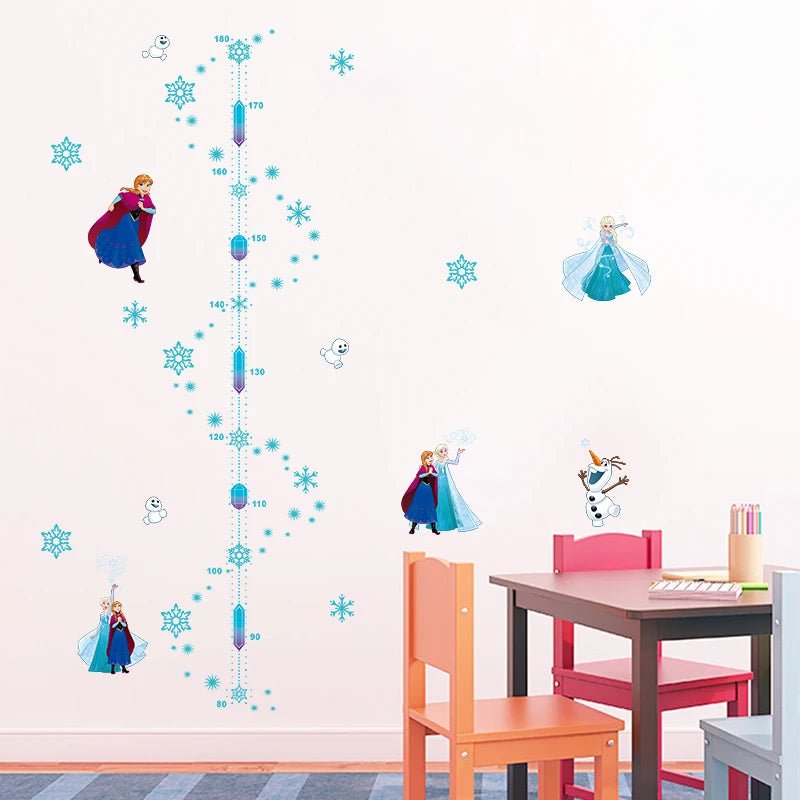 Children's room with Frozen-themed wall decals, table, and chairs.