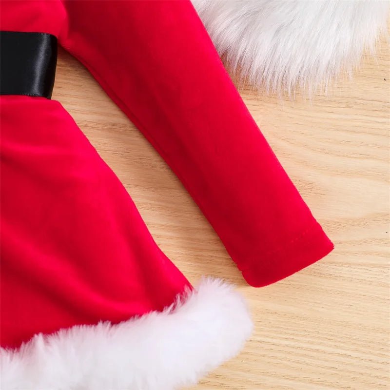 Red fabric with white fur trim on a wooden surface