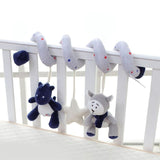 Plush toy rattles hanging from a crib rail with a white background
