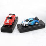 Two toy cars on black stands against a white background