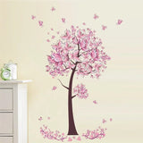 Wall decal of a pink tree with flowers on a beige wall.