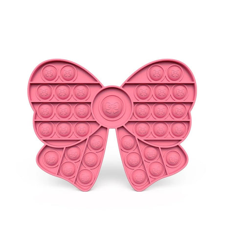 Pink bow-shaped pop-it fidget toy on a white background