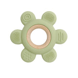 Green teething ring with wooden center on a white background