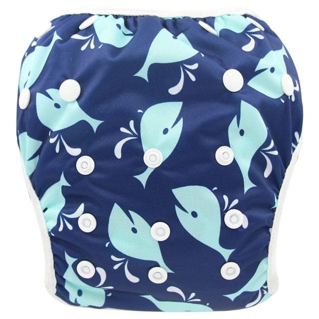 Navy swim diaper with blue whale pattern on a white background