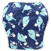Navy swim diaper with blue whale pattern on a white background