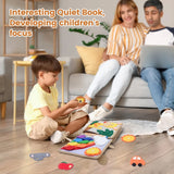 Child playing with a Quiet Book on the floor, parents sitting on a couch using a laptop.