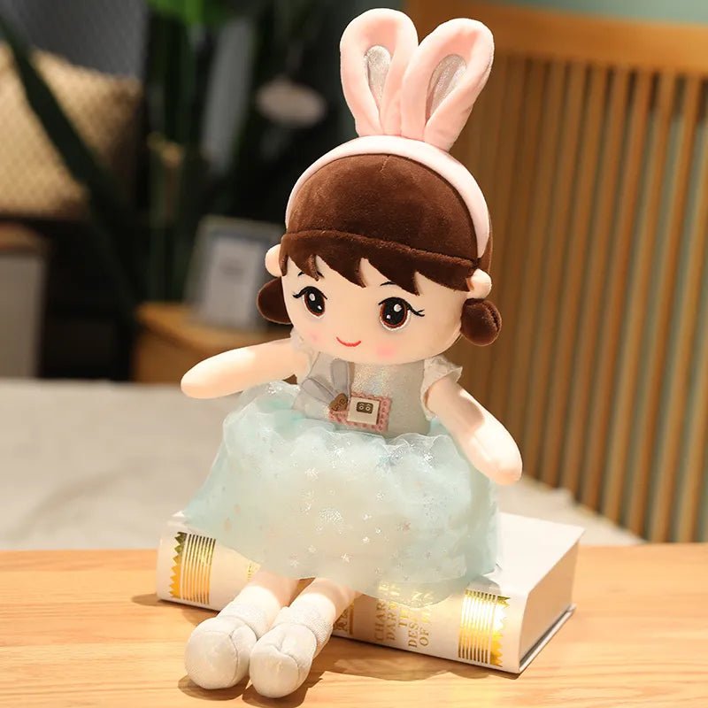 Plush toy with bunny ears sitting on a book