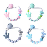 Set of four colorful baby teething toys with 'BABY' letter beads on a white background