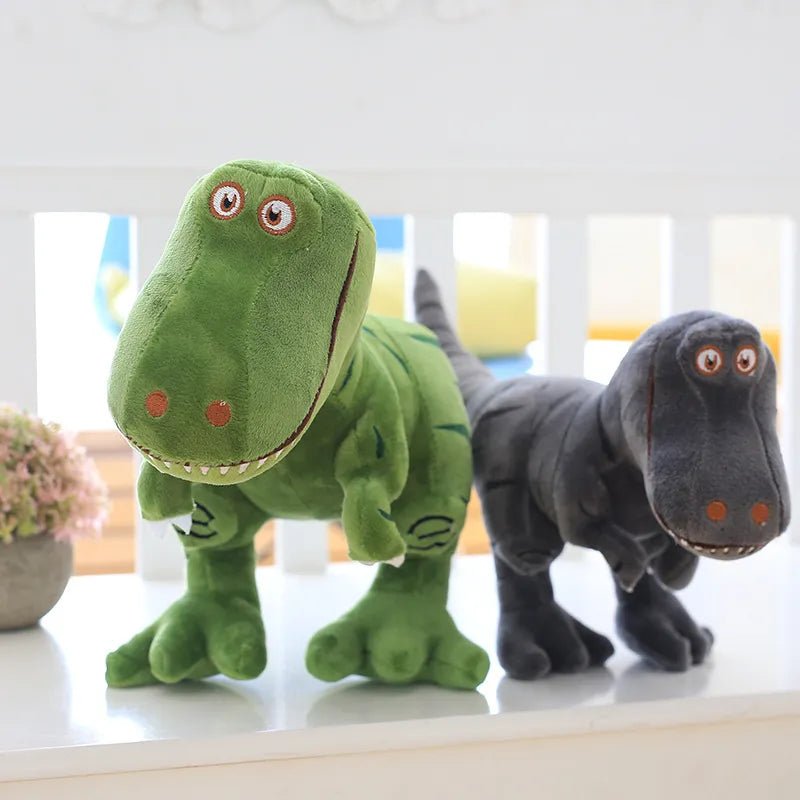 Two plush toy dinosaurs, one green and one gray, on a light surface with a blurred indoor background.