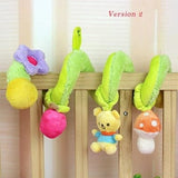 Colorful plush toy hanging on a crib with a wooden background