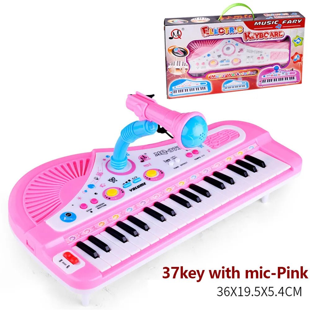 Pink toy keyboard with microphone and packaging on a white background