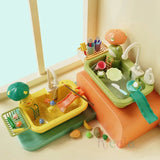 Children's toy kitchen set with various accessories on a light surface.