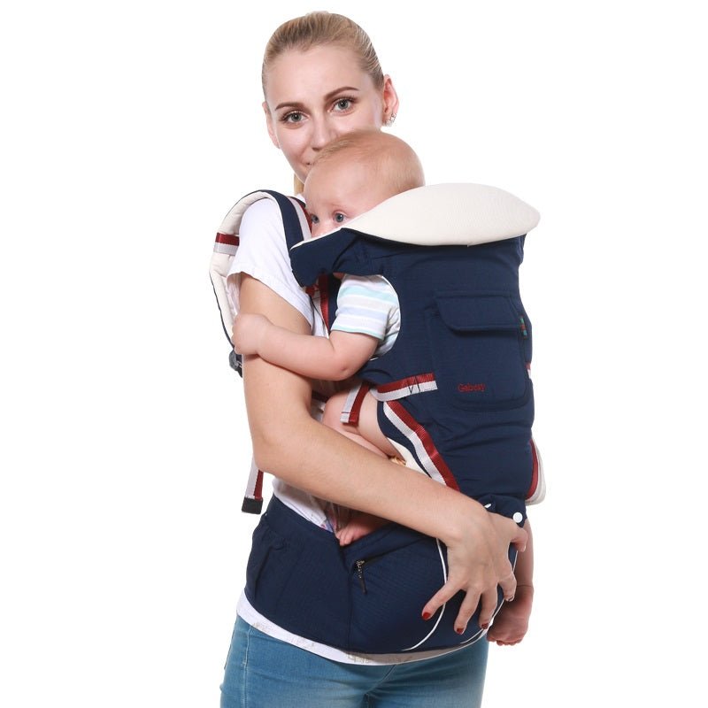 9 in 1 Bebear baby hipseat carrier in navy blue worn front-facing for hands-free babywearing on daily errands.