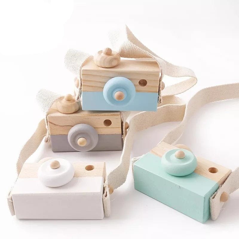 Wooden toy camera with a strap on a white background