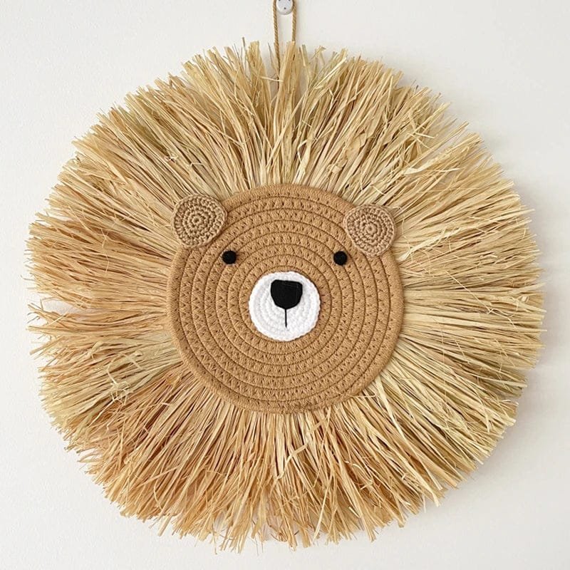 Raffia lion head wall decor on a white background