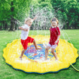 Two children playing on a yellow inflatable sprinkler pad in a grassy area.