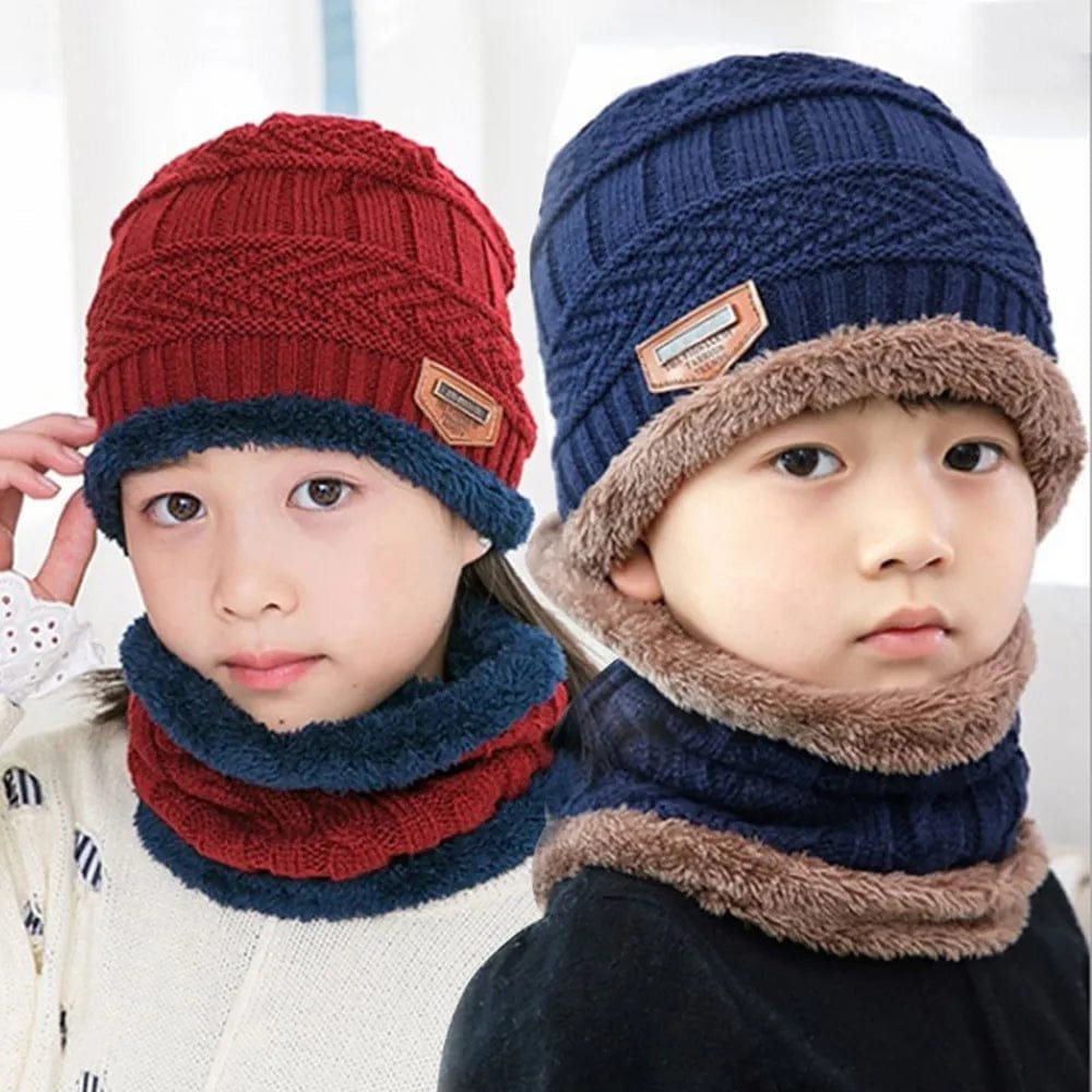 Two children wearing knitted hats and scarves in red, blue, and brown.