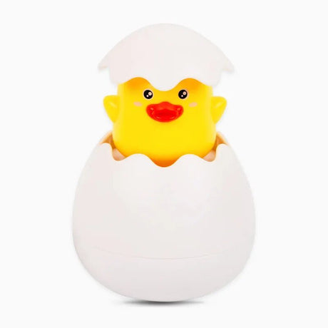Yellow rubber duck in a white egg壳 on a white background