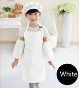 Child wearing a white chef's outfit with a hat in a room setting.