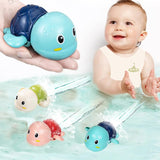 Baby playing with colorful turtle-shaped bath toys in water.