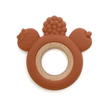 Brown teething ring with acorn design on a white background