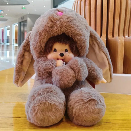 Plush toy resembling a character with bunny ears on a wooden floor.