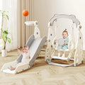 Children's play structure with slide and swing in a room with curtains and plant.