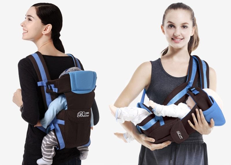 Two women wearing a baby carrier with a baby inside