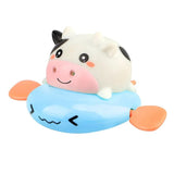 Cute cow-shaped bath toy with a blue base.