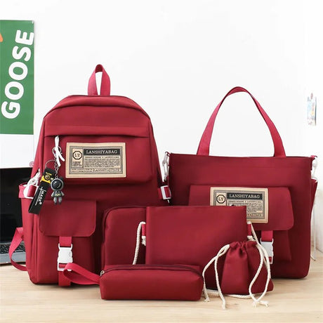 Set of red bags including a backpack, handbag, pouch, and drawstring bag