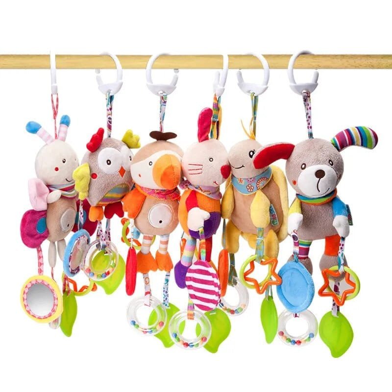 Set of colorful baby rattles with animal designs on a wooden bar.