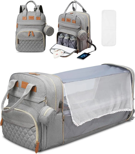 Gray diaper bag with quilted design, backpack straps, and baby bassinet extension 