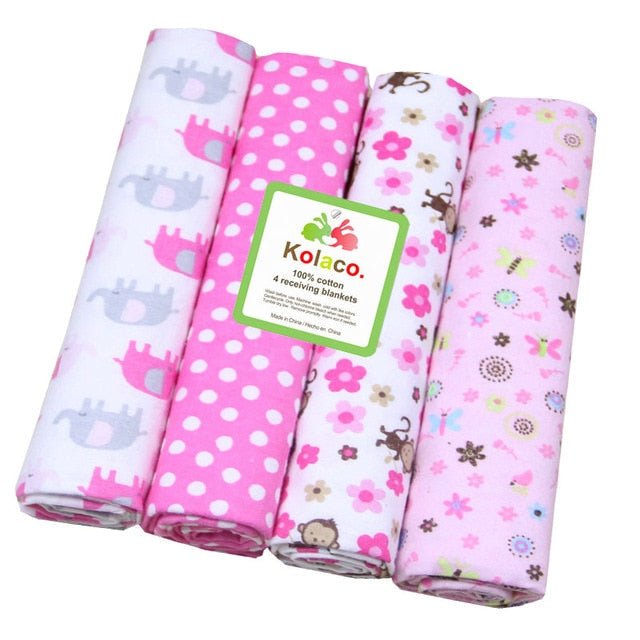 Four colorful baby blankets with patterns and a Kolaco label.