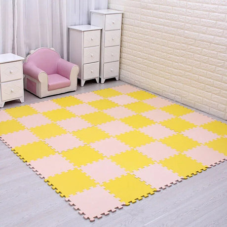 Checkered pink and yellow foam mat on a floor with a pink chair and white dressers in the background.