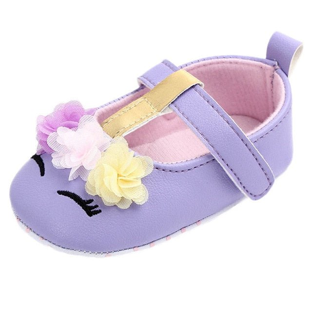 Purple baby shoe with floral decorations 