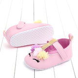 Pink baby shoes with floral details 