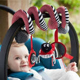 Baby in a stroller with colorful carabiner toy featuring a ladybug design.