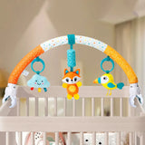 Baby crib arch with colorful toys including a fox, bird, and cloud in a nursery setting.