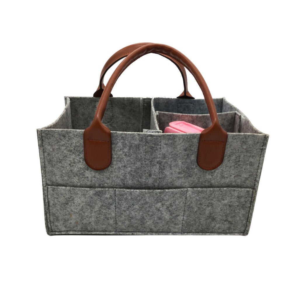 Gray felt tote bag with brown leather handles 
