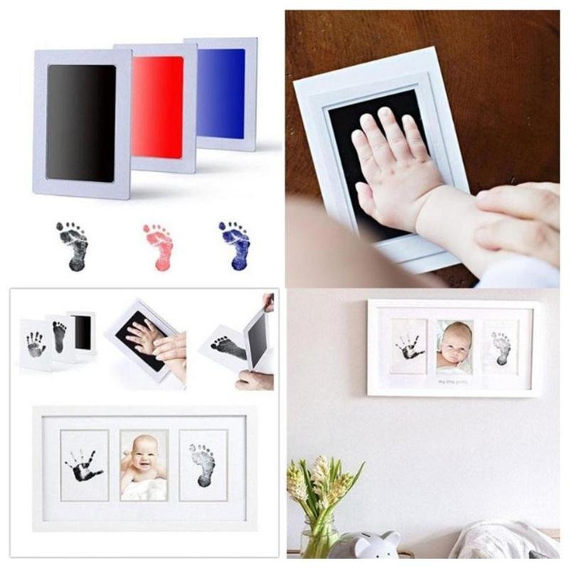 Baby handprint and footprint photo frame with inkless ink pads and printed images.