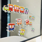 Colorful train-shaped educational stickers on a glass surface