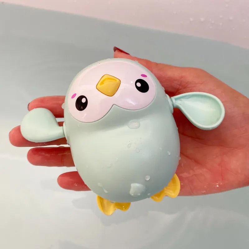 Cute cartoon-style bird toy held in a hand.